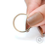 Interior comfort fit view of plain yellow gold wedding band with smooth curved inner surface.