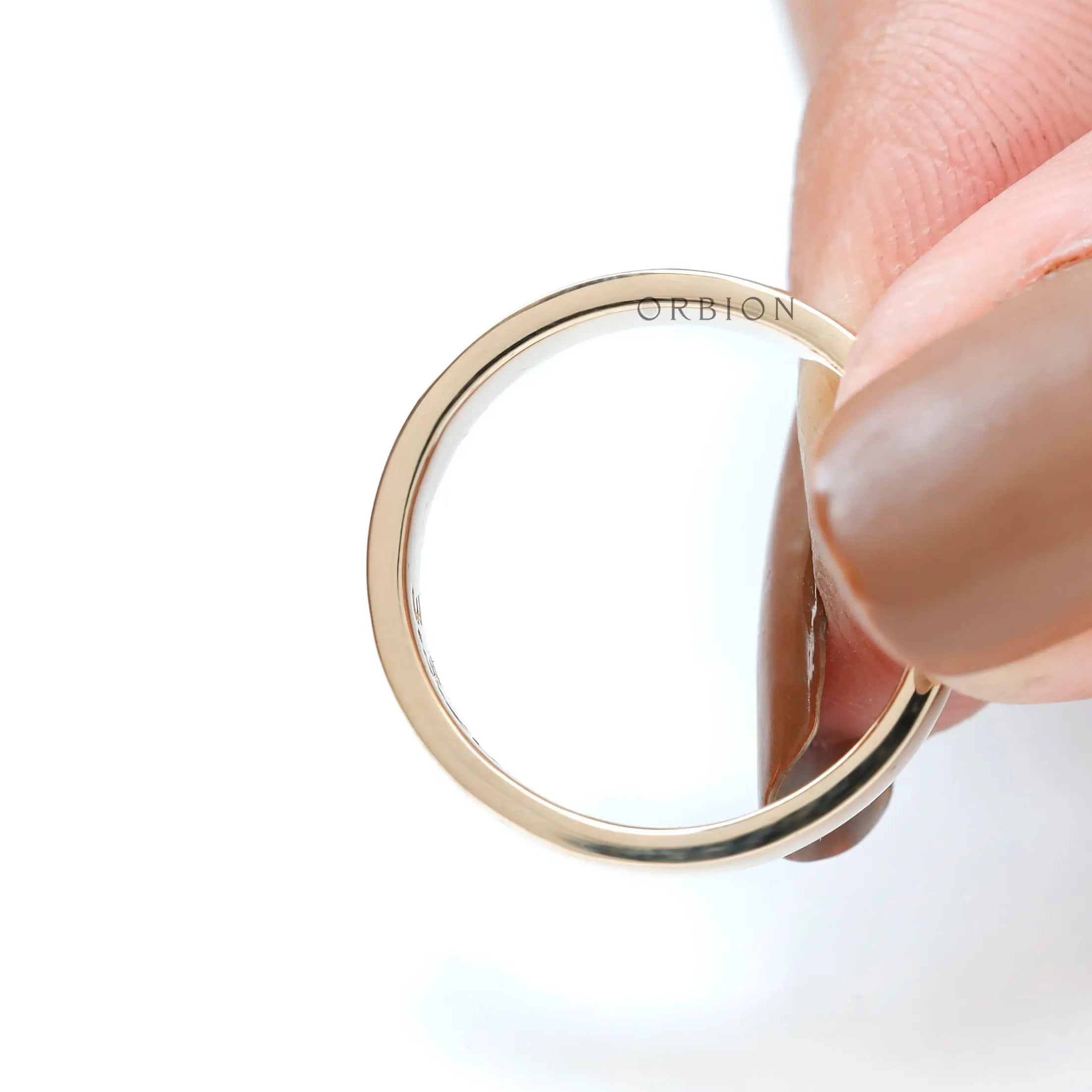 Interior comfort fit view of plain yellow gold wedding band with smooth curved inner surface.