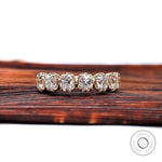 Front view of 7 stone half eternity wedding band in yellow gold with vintage prong setting