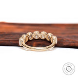 Back view of 7 stone half eternity band showing open gallery and plain comfort-fit shank