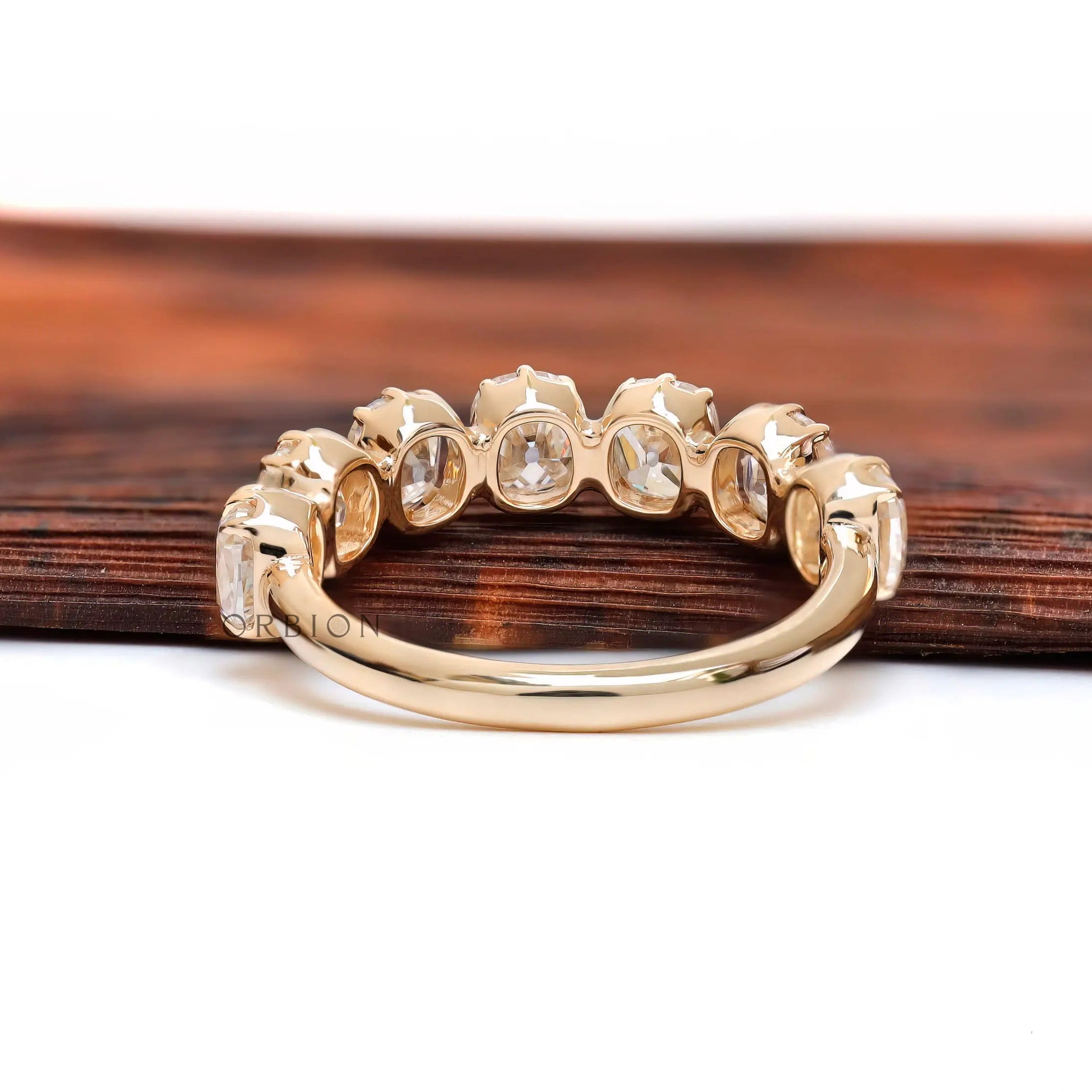Back view of 7 stone half eternity band showing open gallery and plain comfort-fit shank