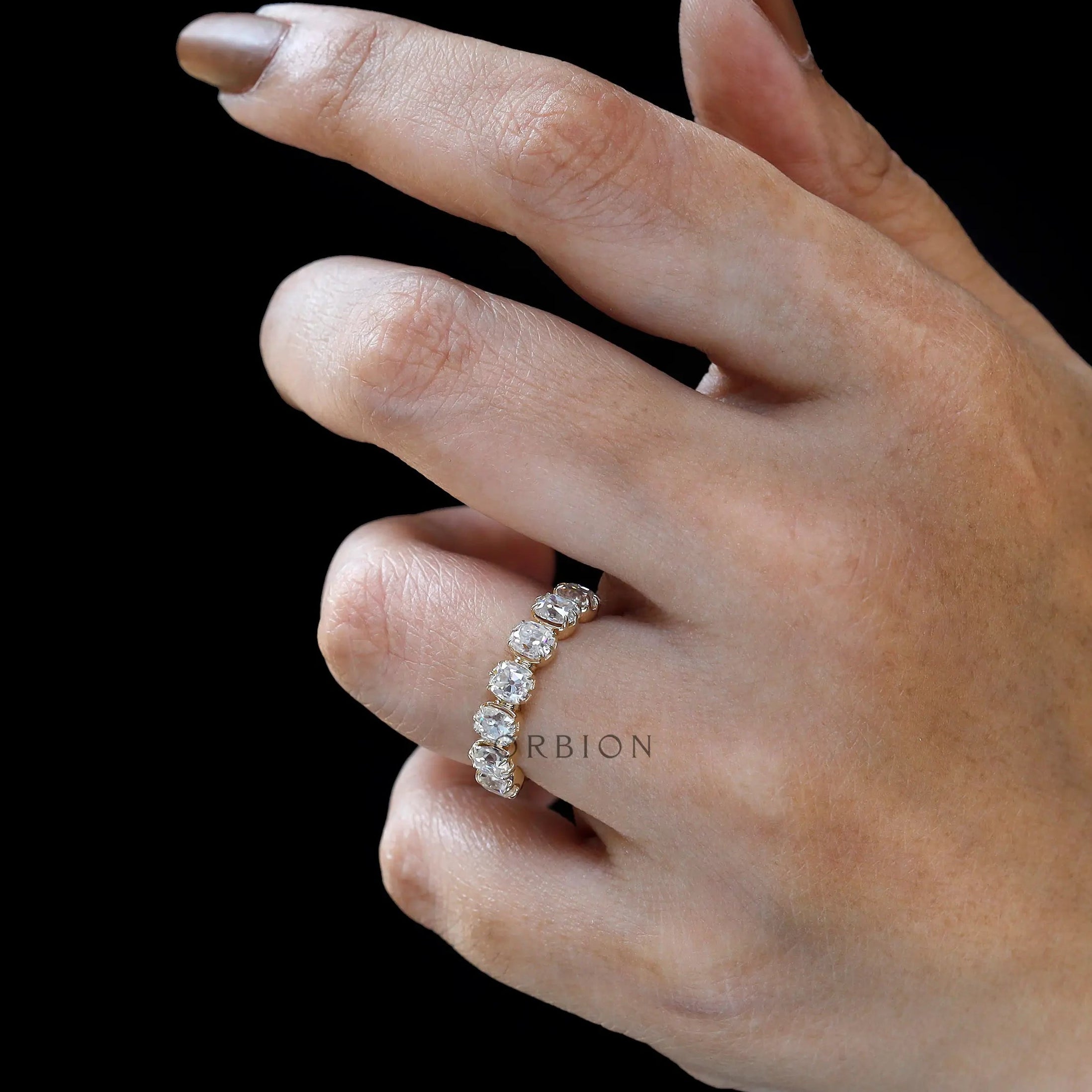 On-hand view of 7 moissanite vintage stacking wedding band in yellow gold