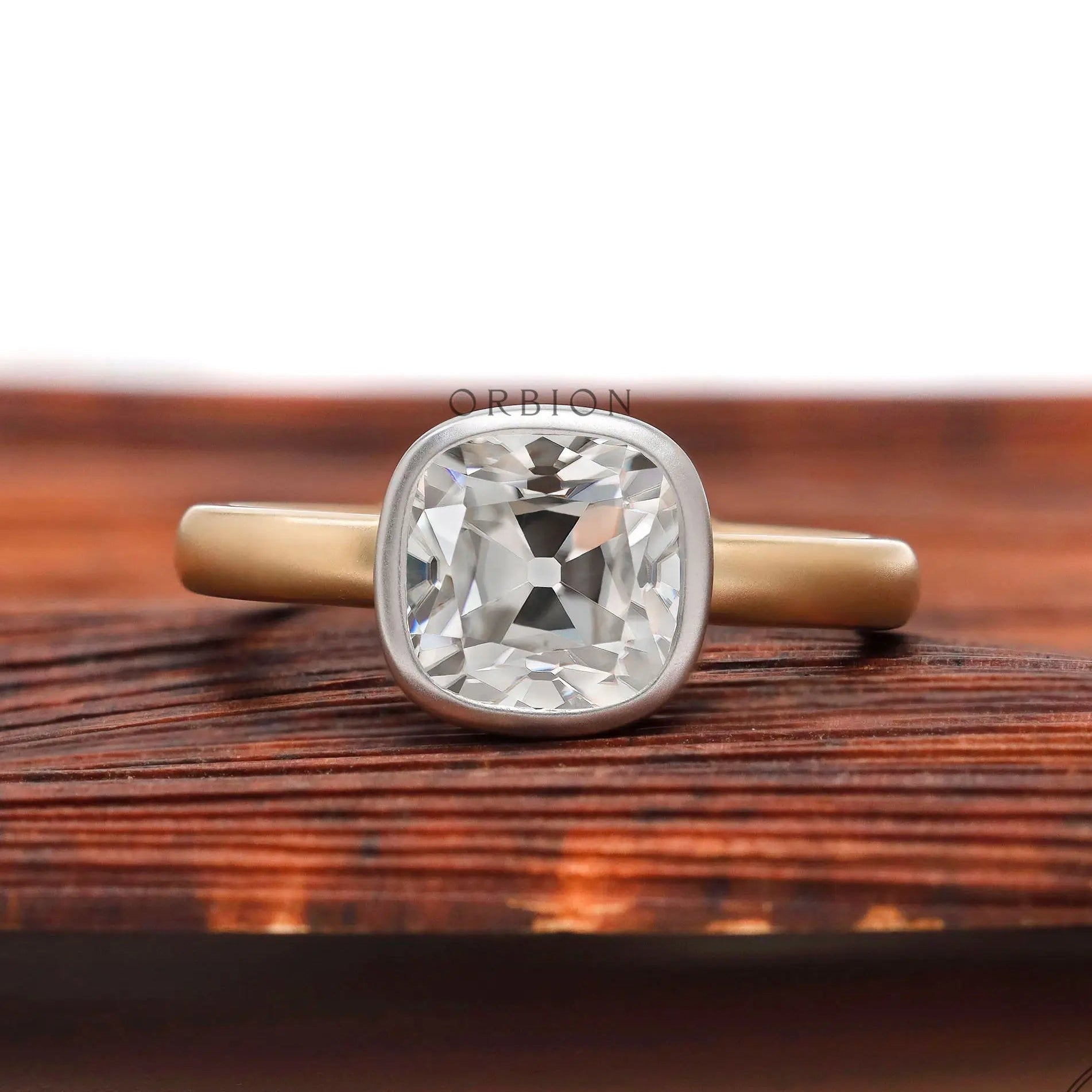 Dual tone cushion Old Mine Cut moissanite bezel solitaire ring