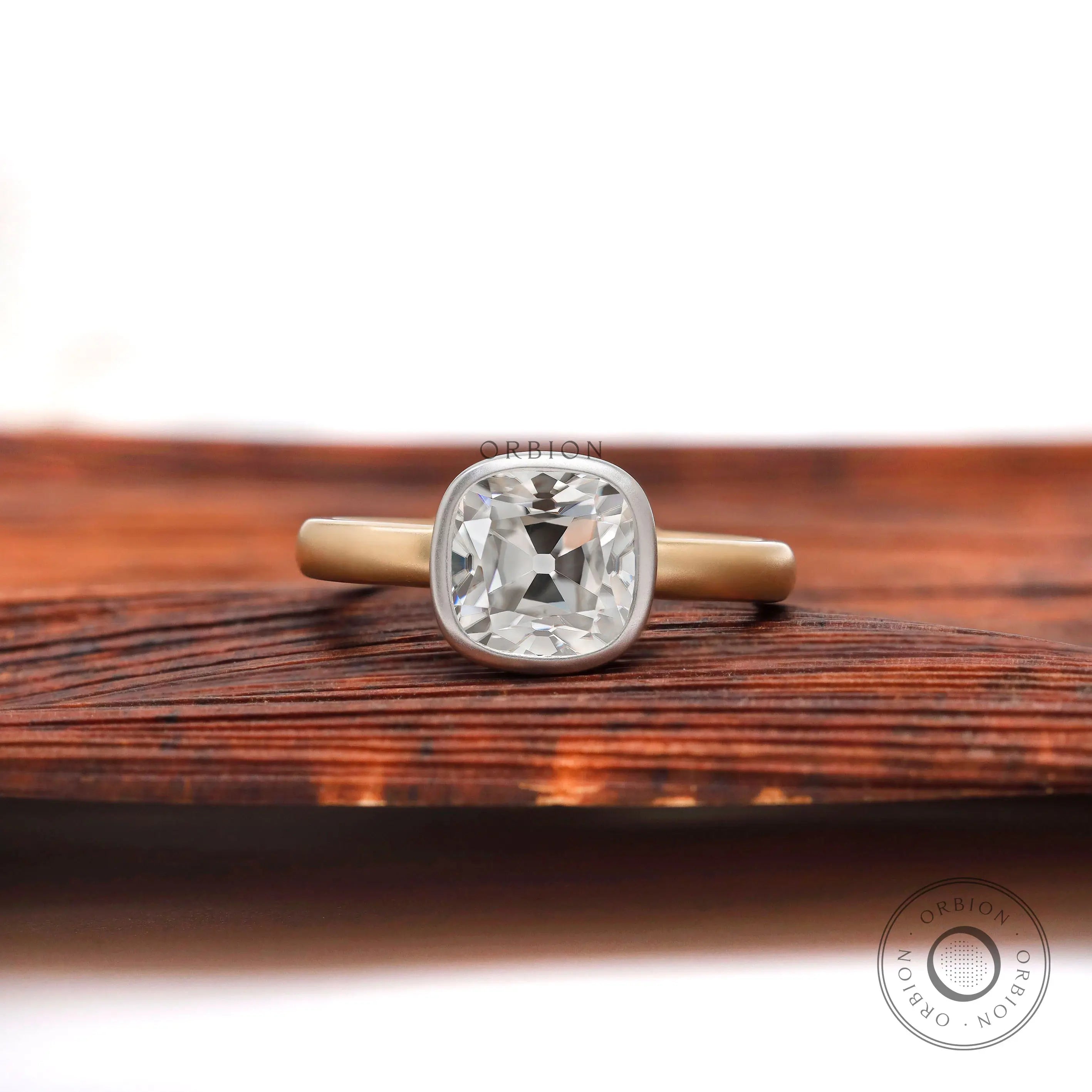 Dual tone cushion Old Mine Cut moissanite bezel solitaire ring