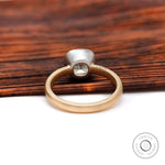 Two tone gold bezel set cushion engagement ring