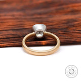Two tone gold bezel set cushion engagement ring