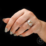 Three stone vintage ring shown on hand, top view sparkle
