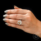 Close up on hand highlighting dark champagne cushion moissanite
