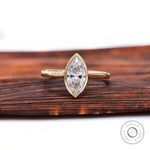 Marquise bezel solitaire cathedral engagement ring in yellow gold front view