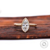 Marquise bezel solitaire cathedral engagement ring in yellow gold front view