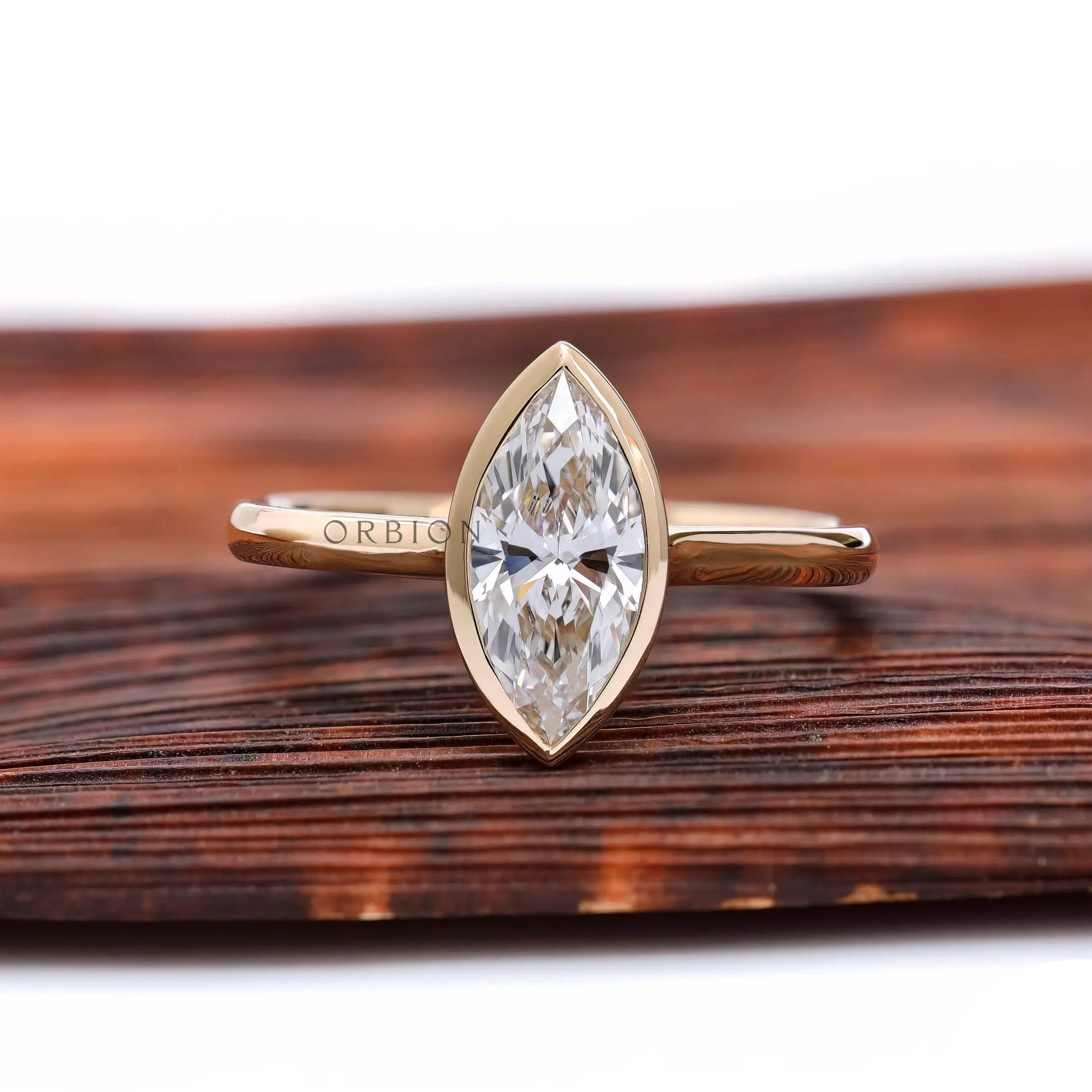 Marquise bezel solitaire cathedral engagement ring in yellow gold front view