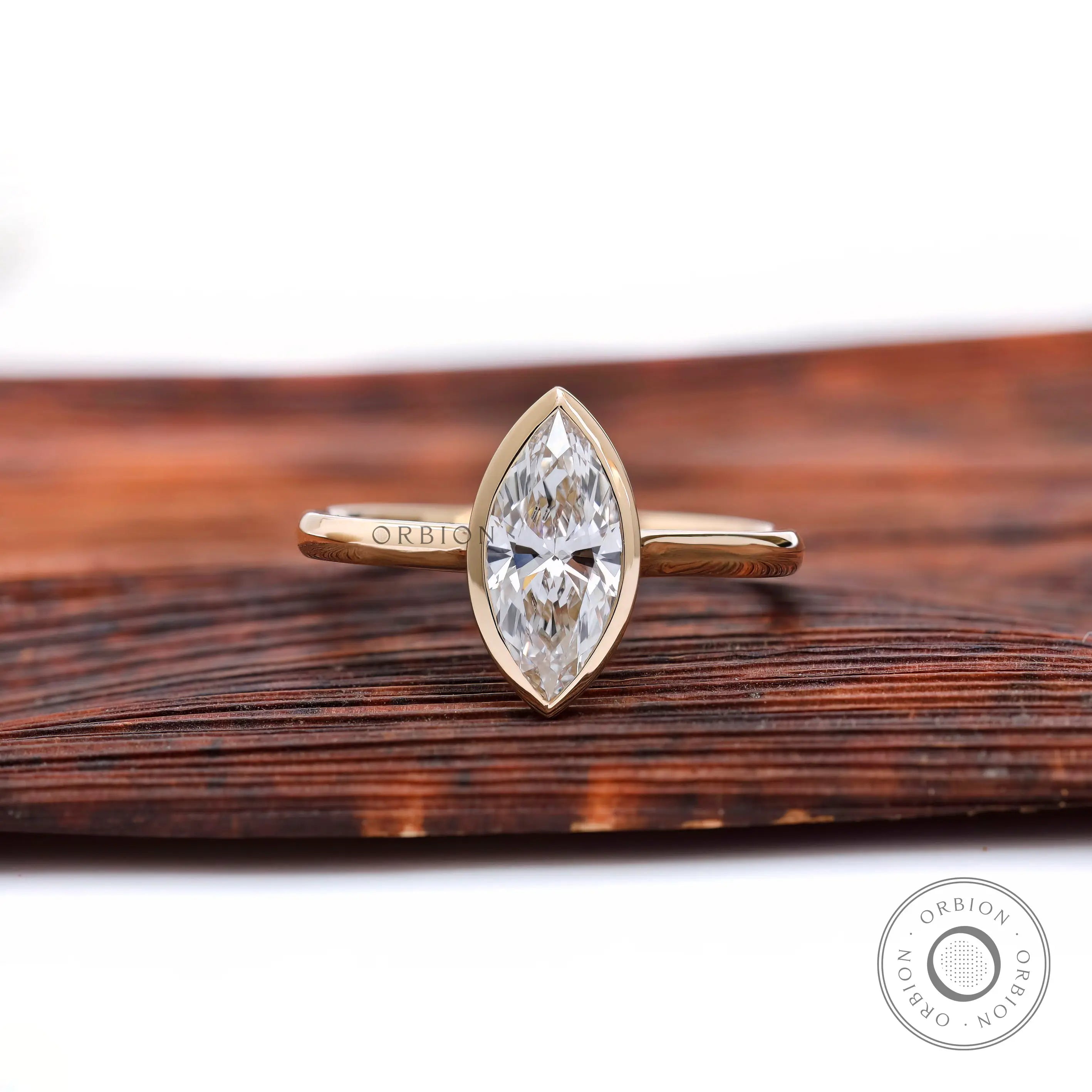 Marquise bezel solitaire cathedral engagement ring in yellow gold front view