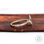 Side profile showing cathedral shoulders and low bezel marquise setting