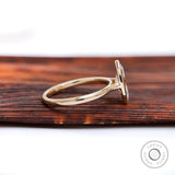 Side profile showing cathedral shoulders and low bezel marquise setting