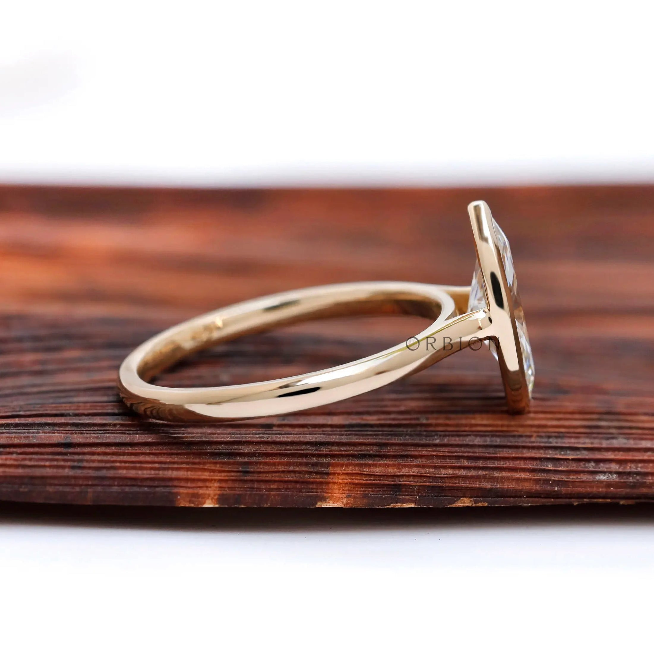 Side profile showing cathedral shoulders and low bezel marquise setting