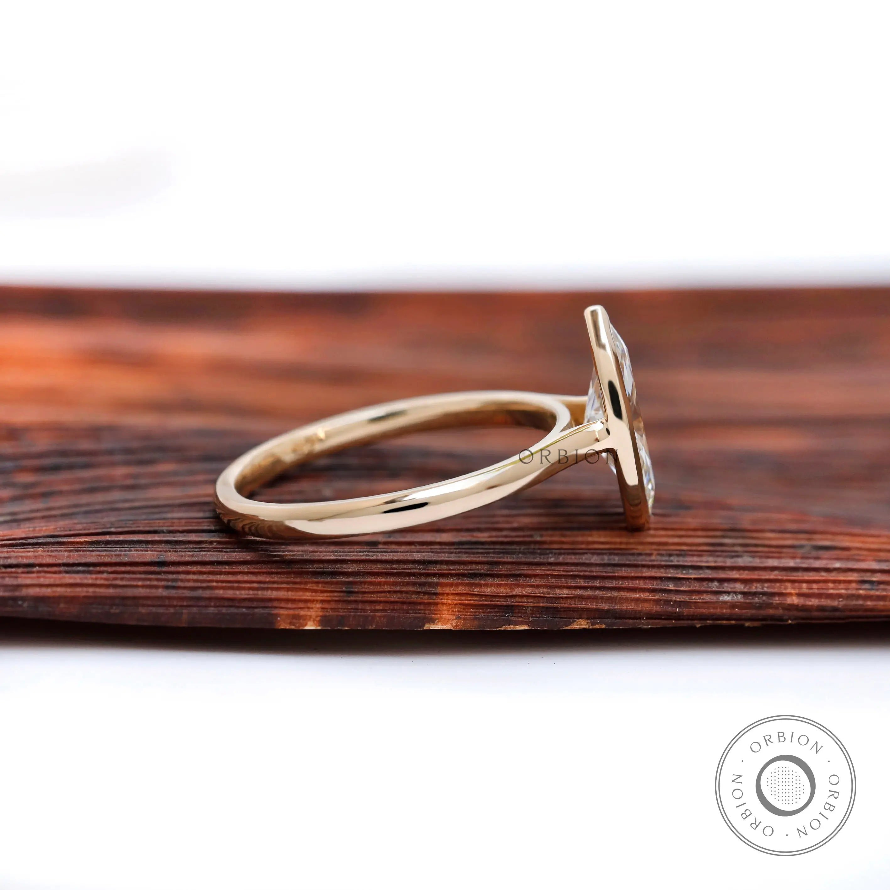 Side profile showing cathedral shoulders and low bezel marquise setting