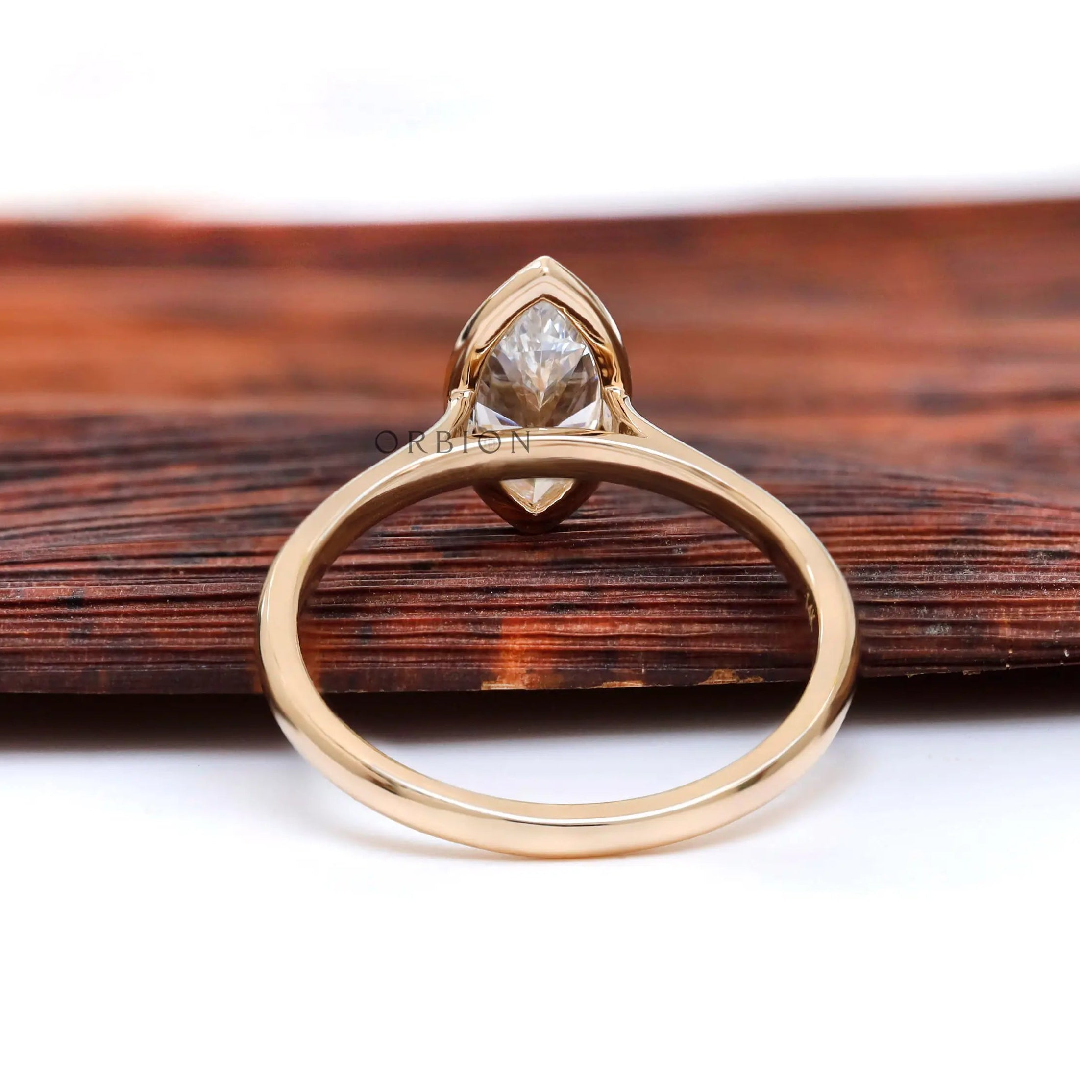 Underside view highlighting cathedral structure and bezel set marquise stone