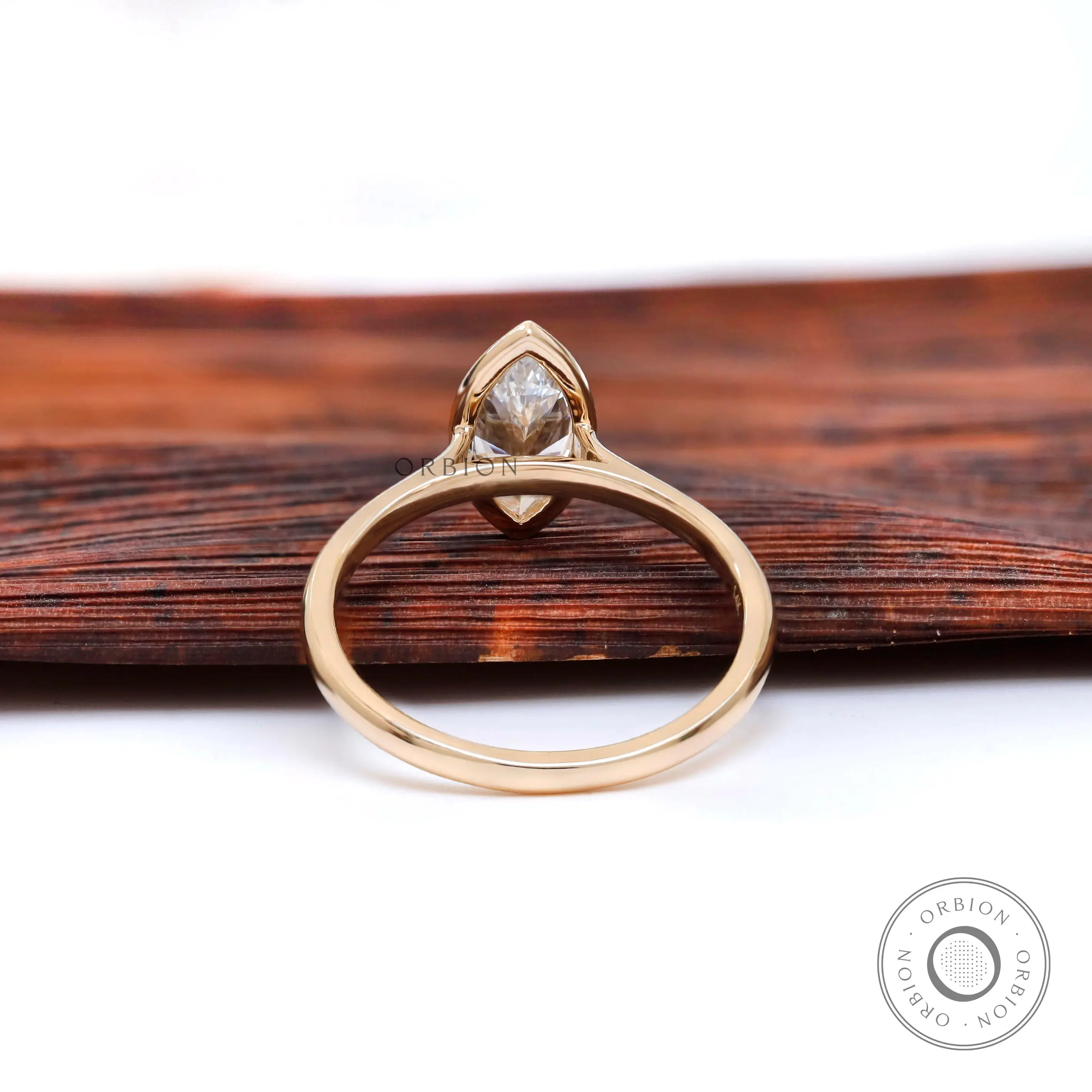 Underside view highlighting cathedral structure and bezel set marquise stone