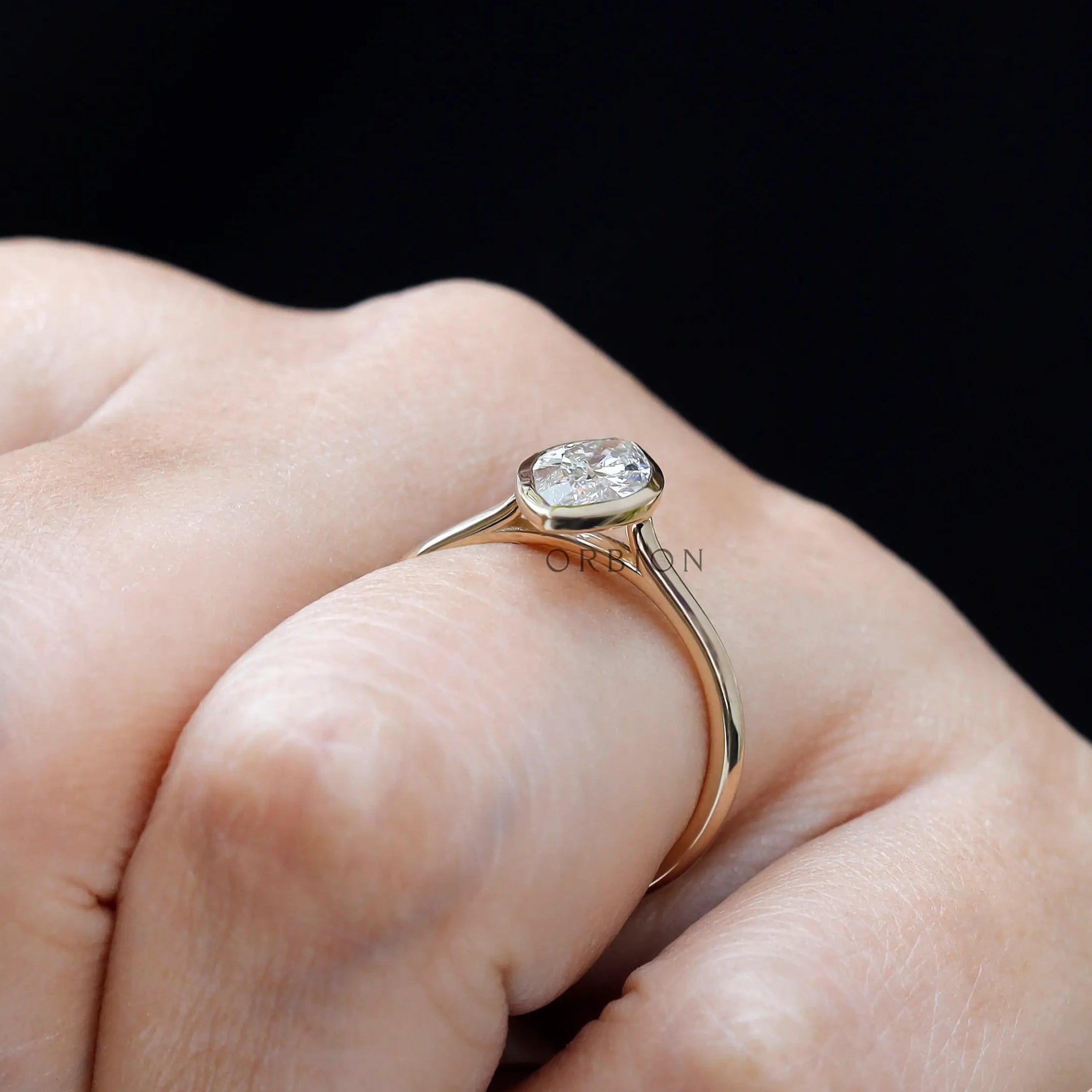 Side angle on-hand shot showing low profile bezel and cathedral design