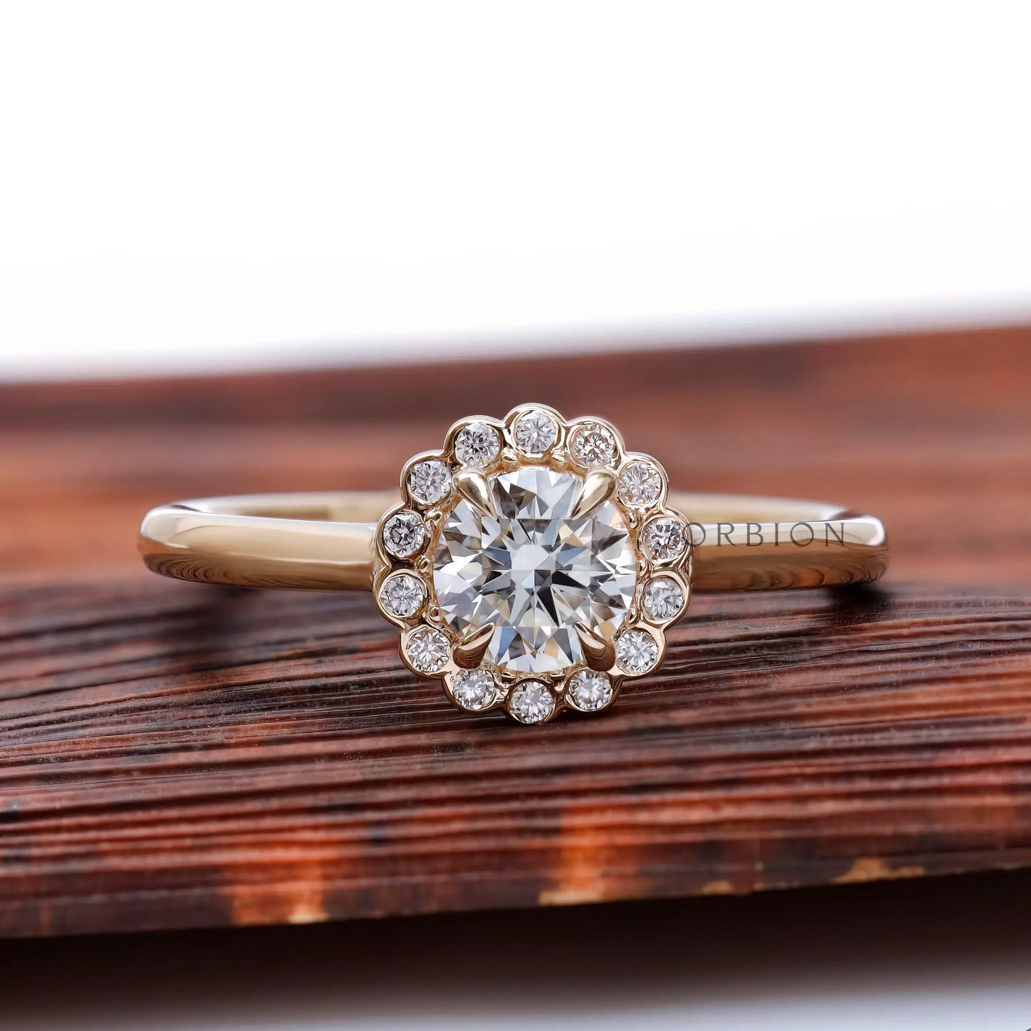 Front view round lab grown diamond with snowdrift cluster halo in yellow gold.