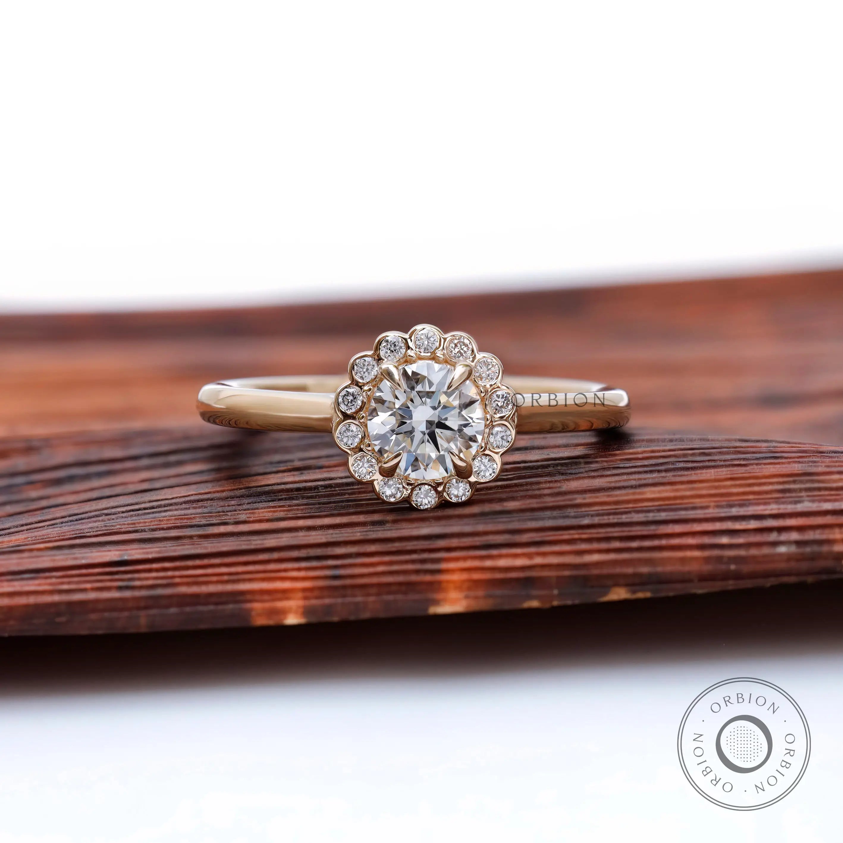 Front view round lab grown diamond with snowdrift cluster halo in yellow gold.