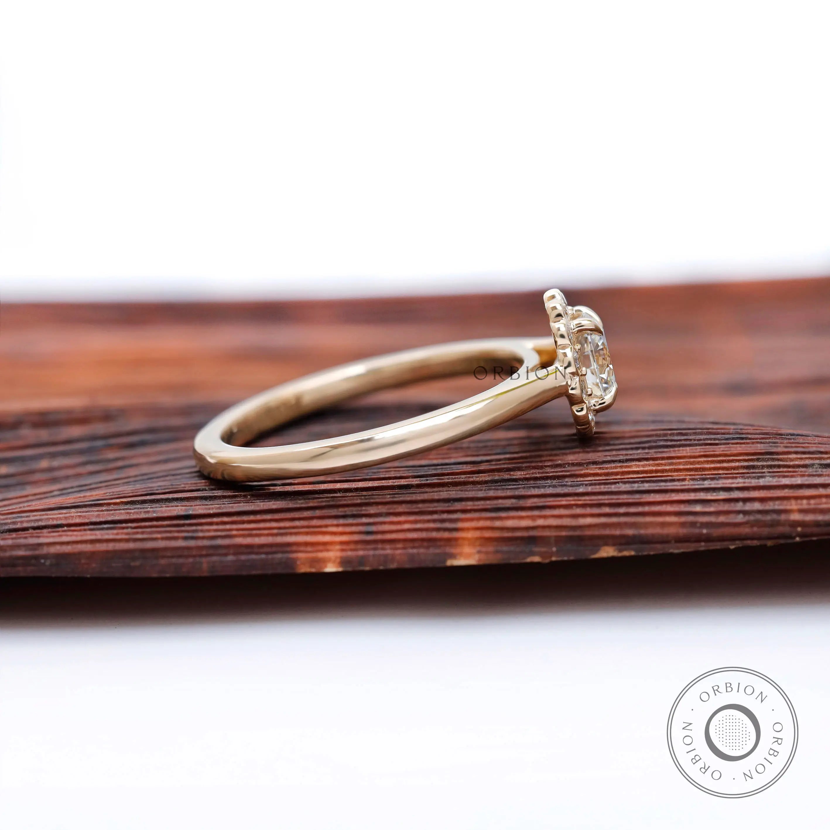 Side profile showing low-set cluster head and smooth yellow gold shank.