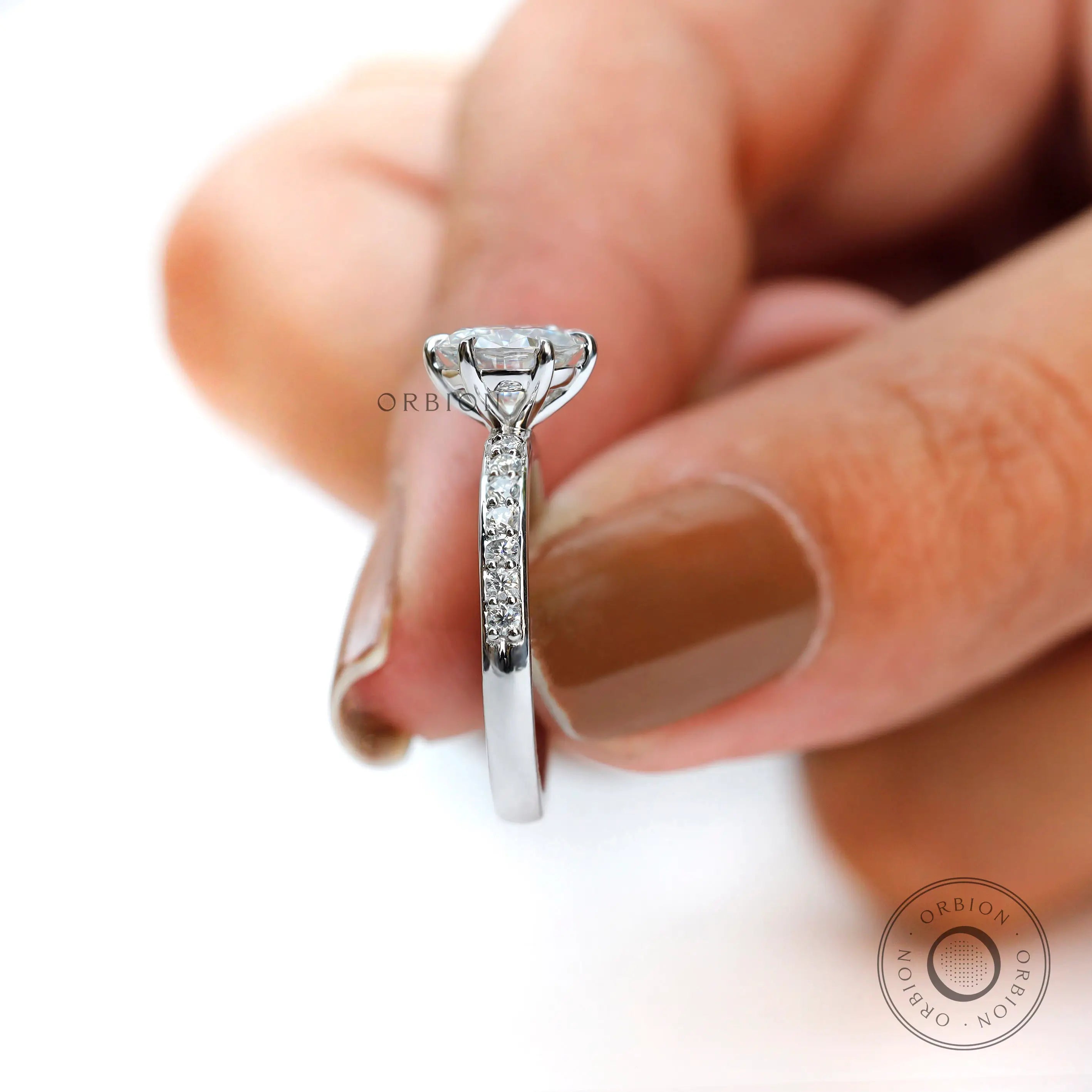 Close-up side view highlighting pave stones and elegant setting.