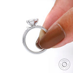 Hand-held side profile showing ring height, basket design, and pave detailing.