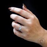 Angled lifestyle view showing six-prong solitaire and pave band sparkle.