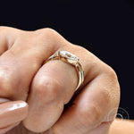 Contemporary marquise solitaire bridal ring set on finger