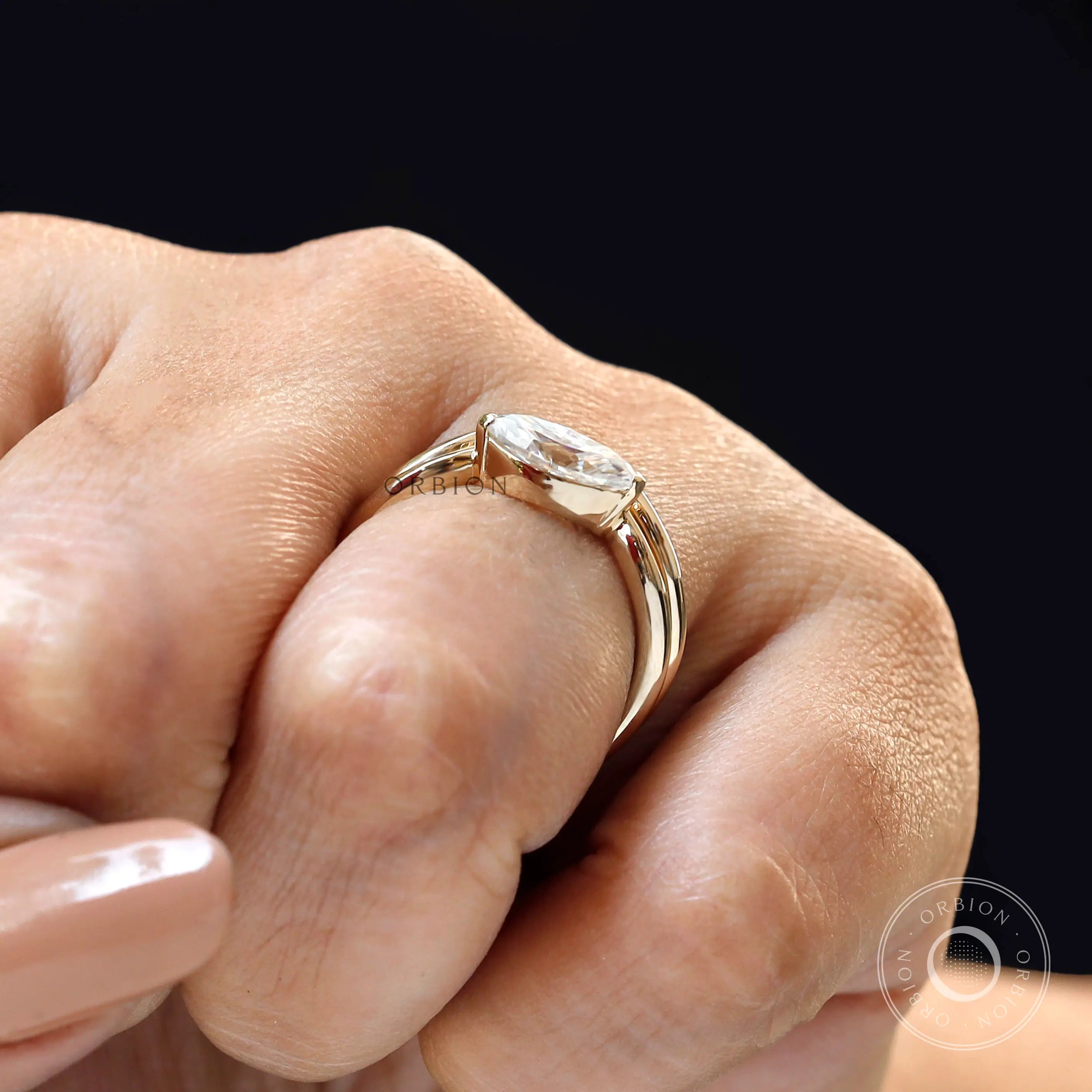 Contemporary marquise solitaire bridal ring set on finger