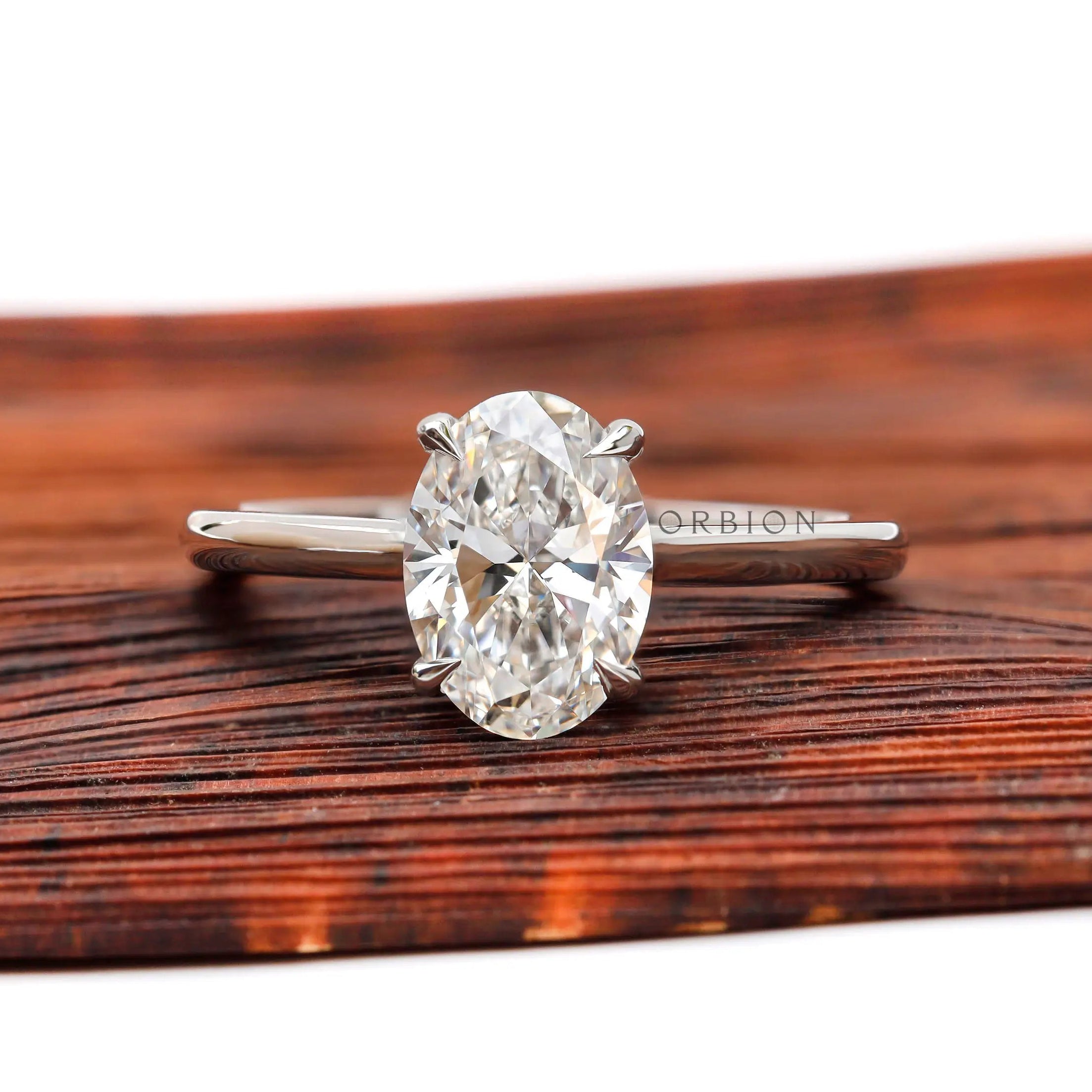 Oval lab grown diamond solitaire ring with cathedral setting in 14K white gold