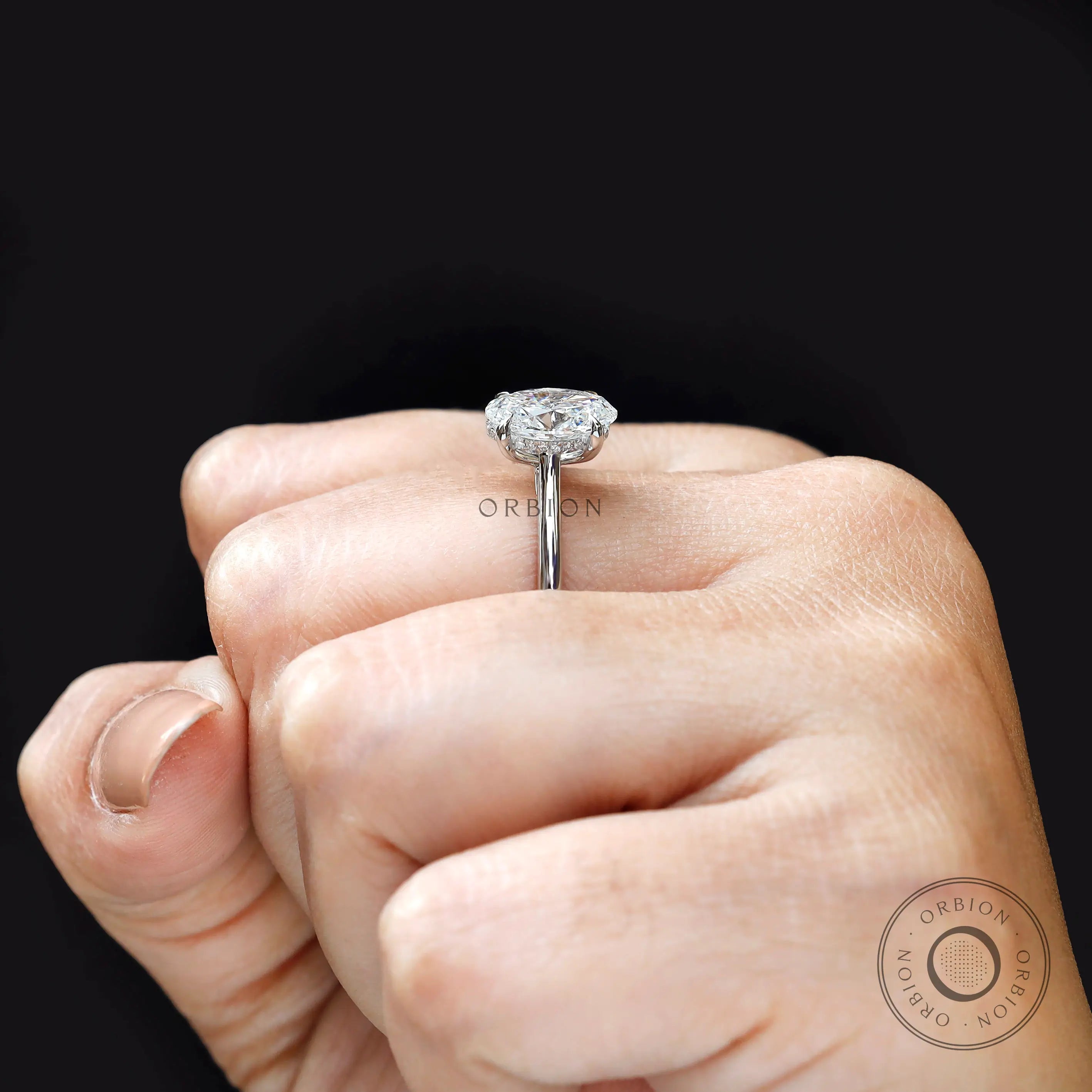Hand model wearing oval lab grown diamond solitaire ring