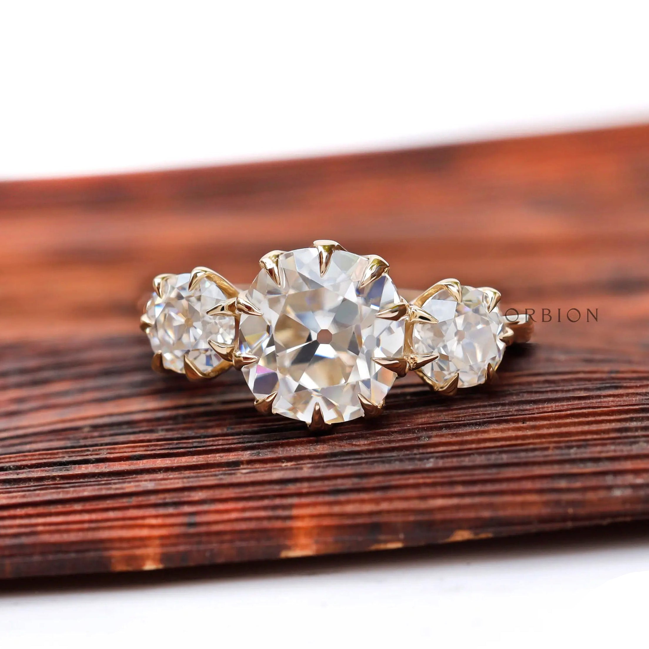 Georgian style three stone ring, cushion center with two side stones.