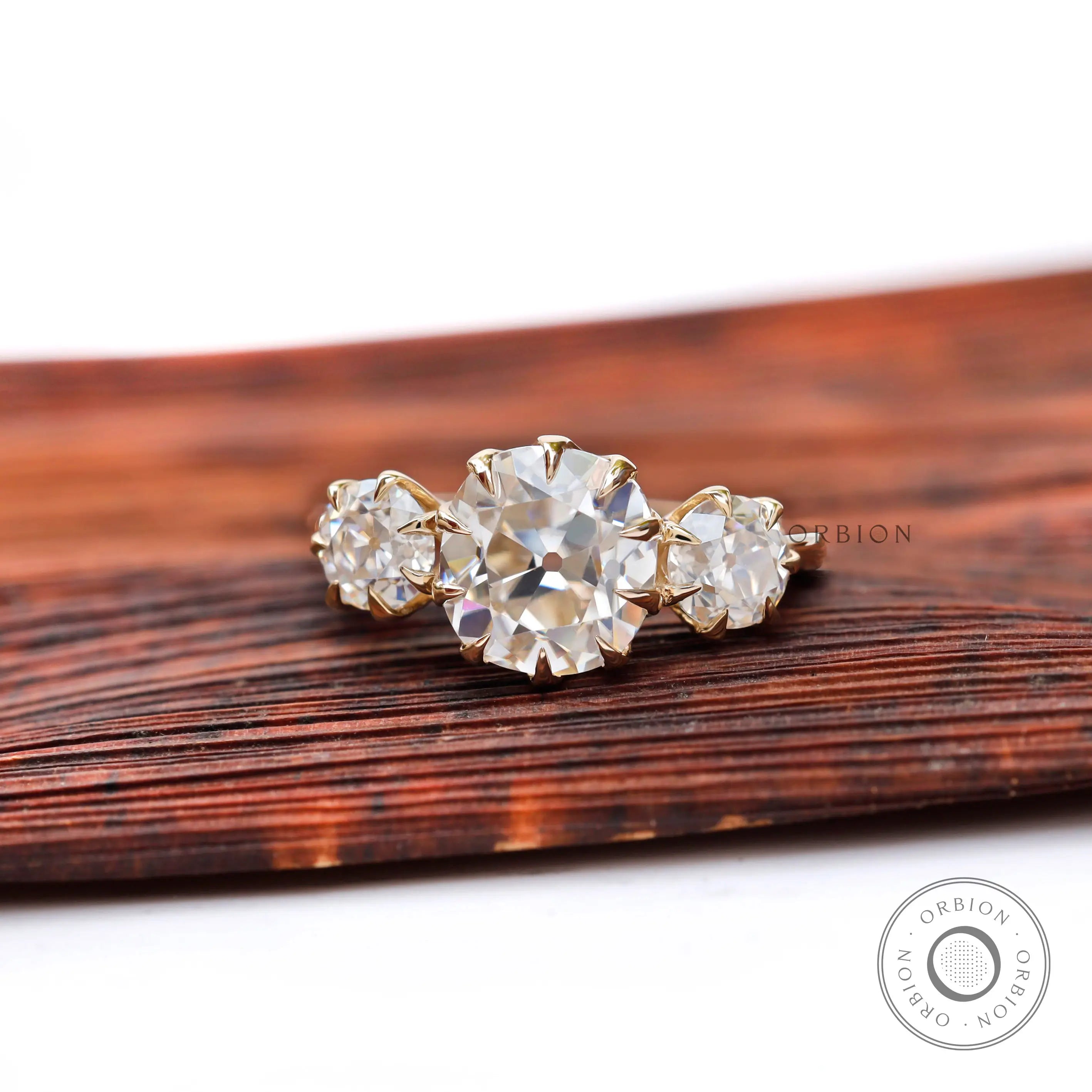 Georgian style three stone ring, cushion center with two side stones.