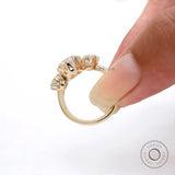 Hand held view showing raised trilogy setting and crown prong structure.