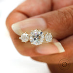 Close up of round three stone ring with Georgian inspired claw prongs.