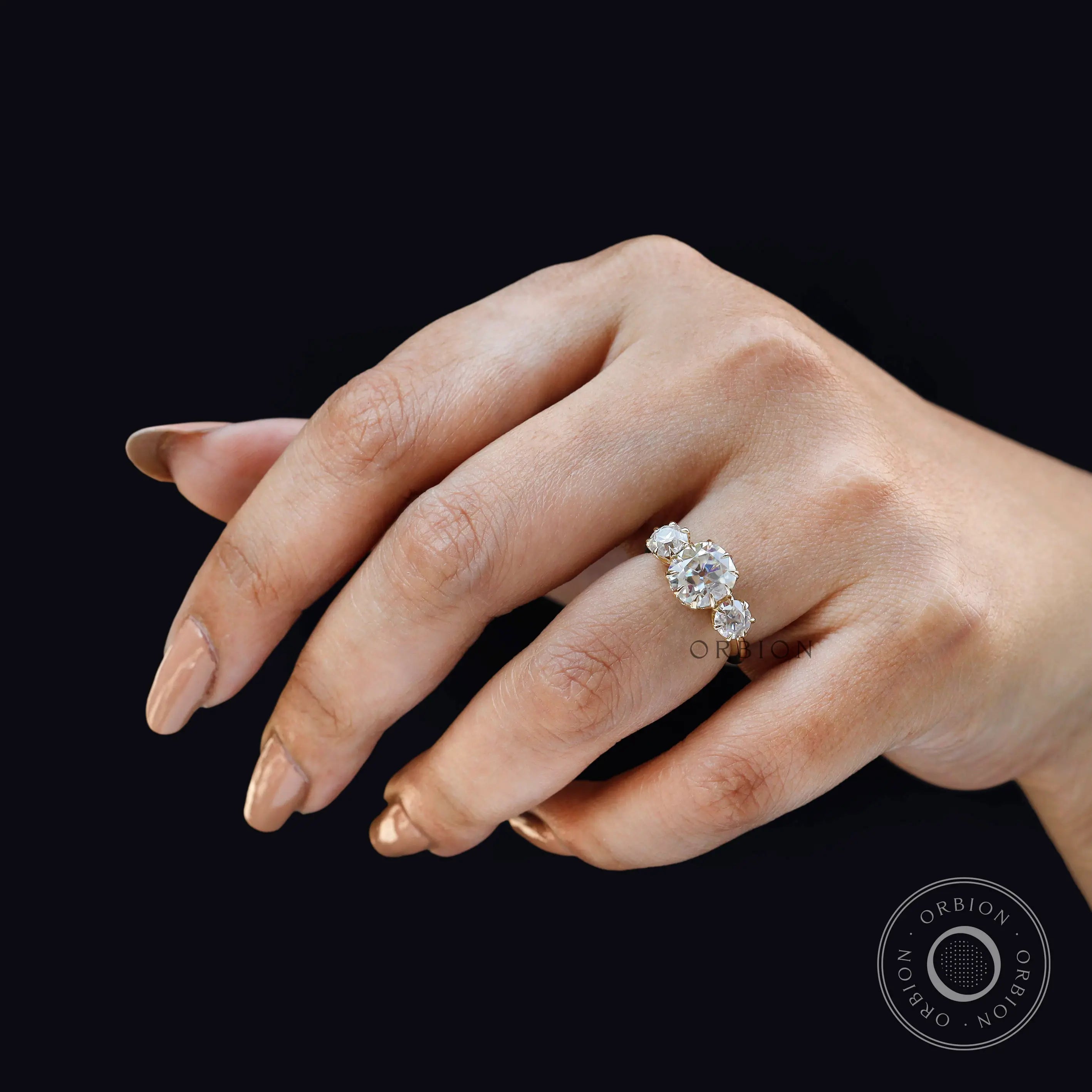 Angled on hand view showing vintage sparkle and elevated center setting.