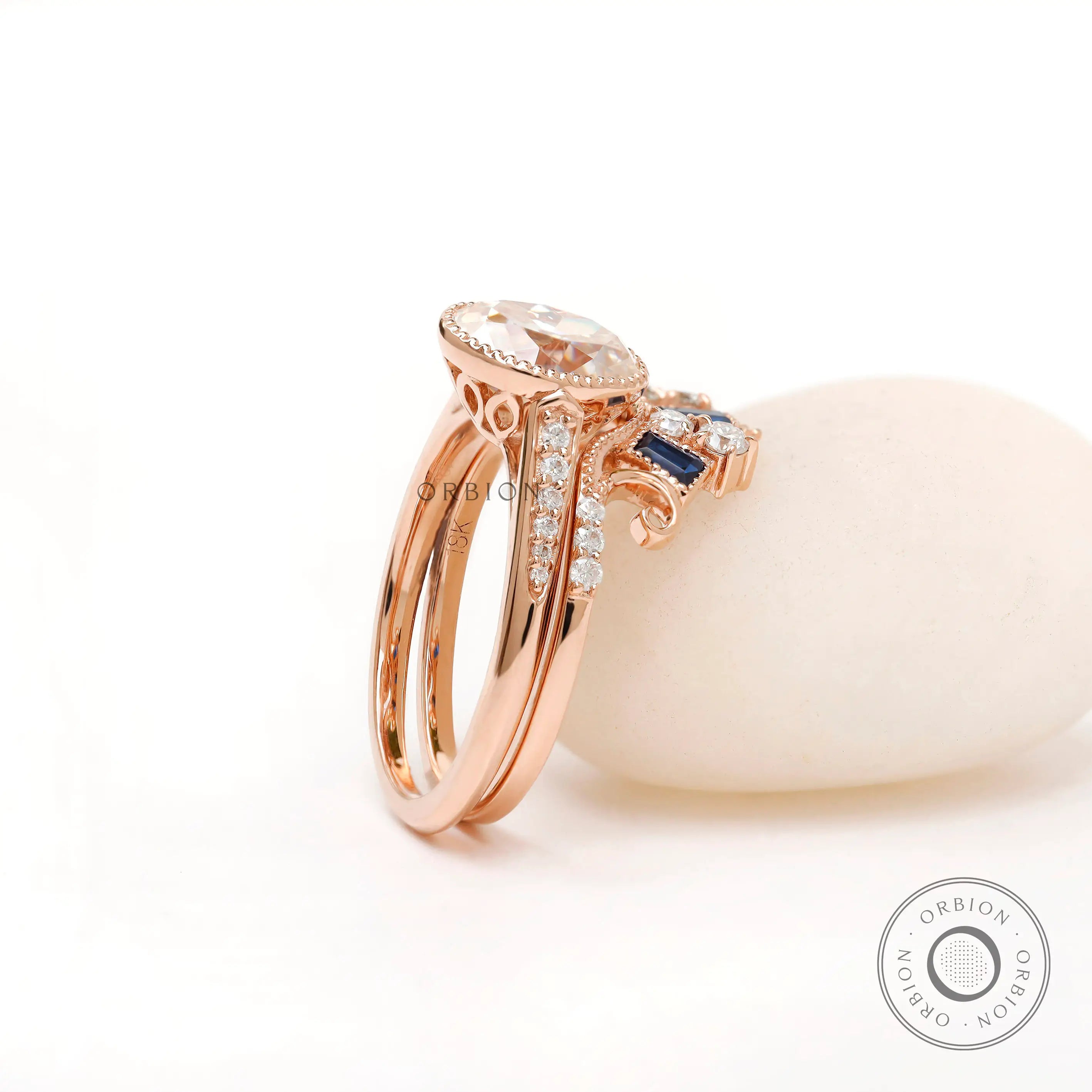 Curved band with blue tapered baguette stones in rose gold