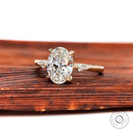 Oval moissanite three stone engagement ring with kite shaped side diamonds