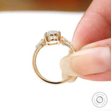 Three stone engagement ring with oval center and kite side diamonds