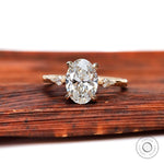 Oval cut lab diamond three stone engagement ring with kite side stones in yellow gold