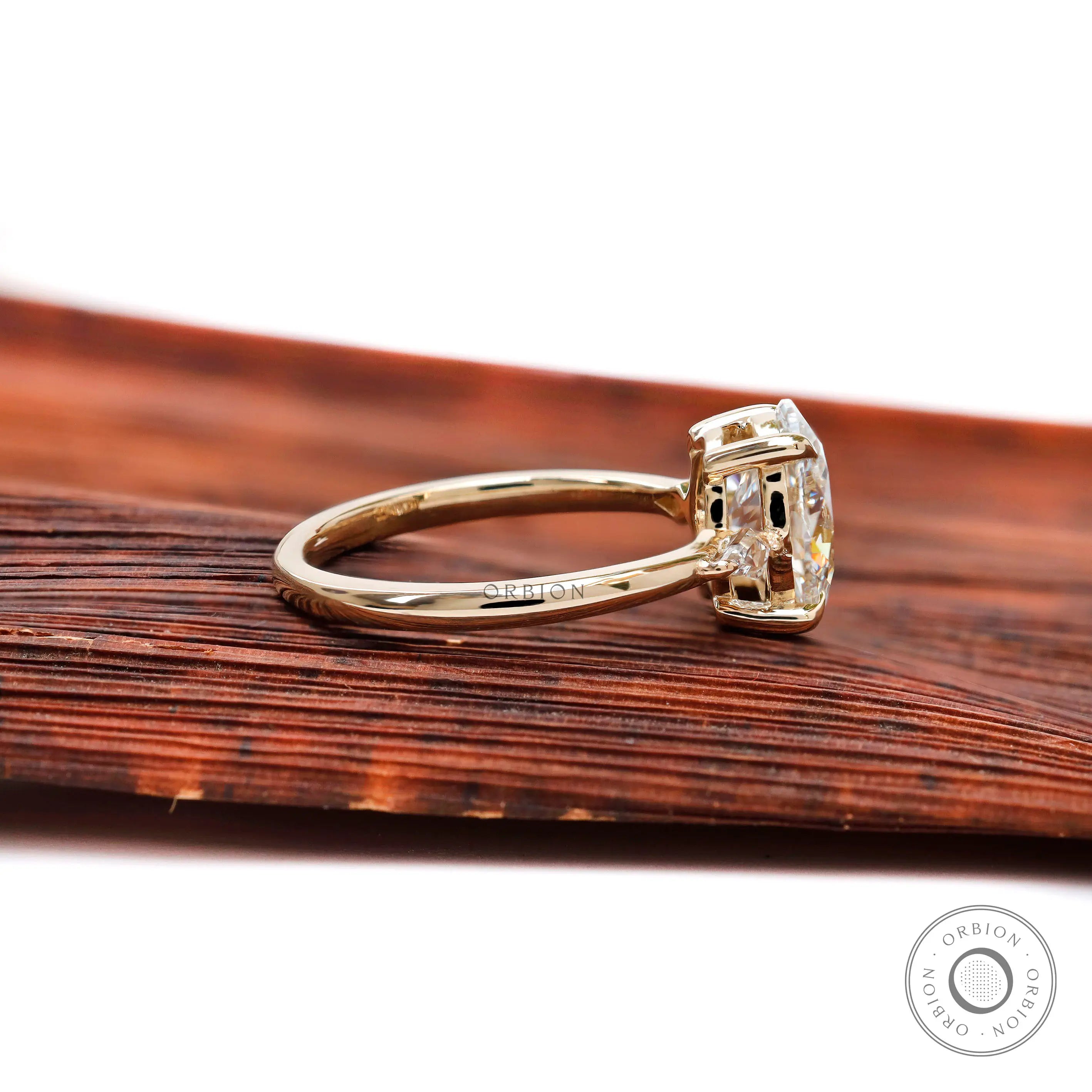 Three stone oval engagement ring with kite side stones 14k yellow gold