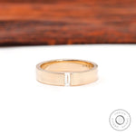 Front view of cigar wedding band with flush set baguette moissanite center.