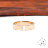 Front view of cigar wedding band with flush set baguette moissanite center.