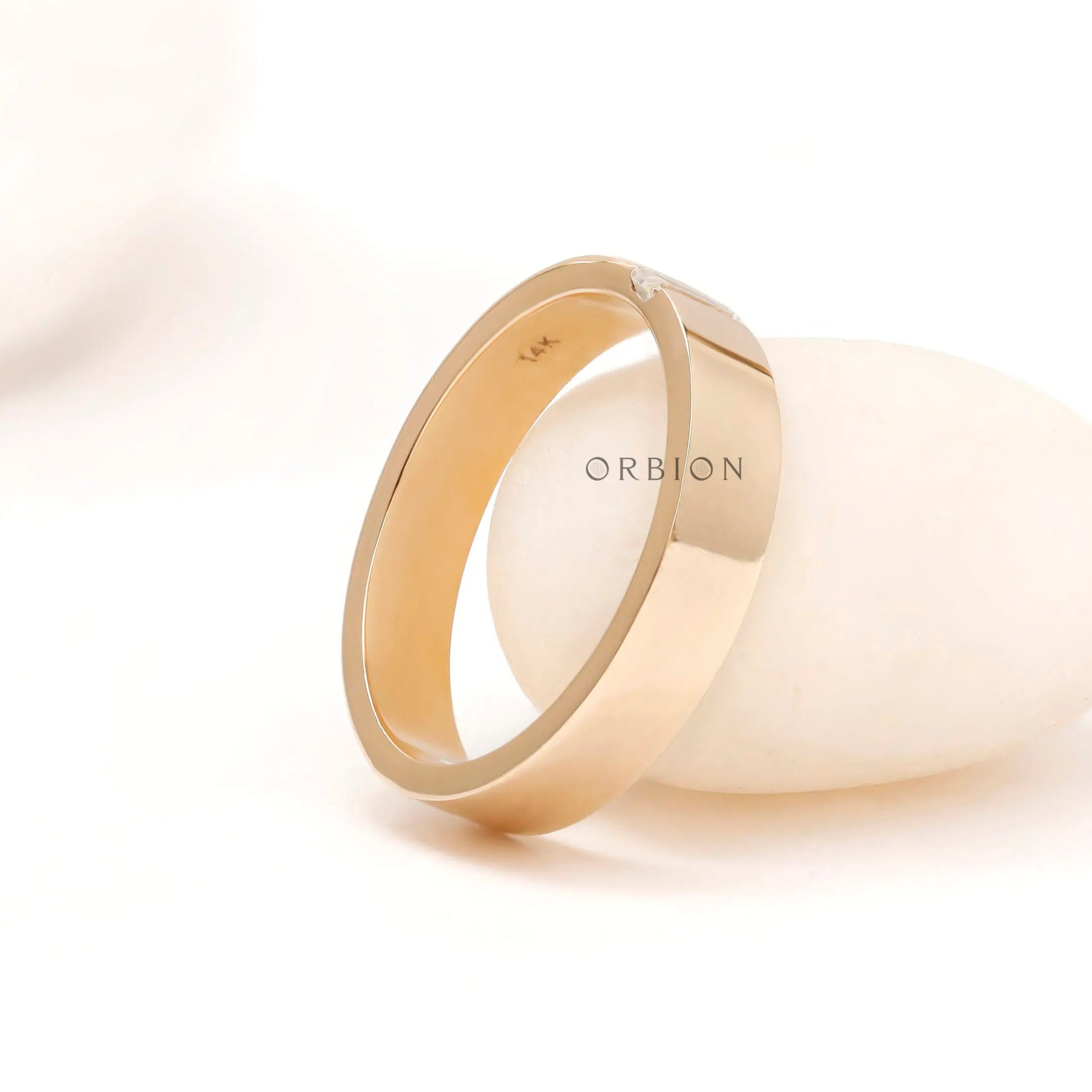 Side profile of cigar band showing low-profile baguette a white prop.