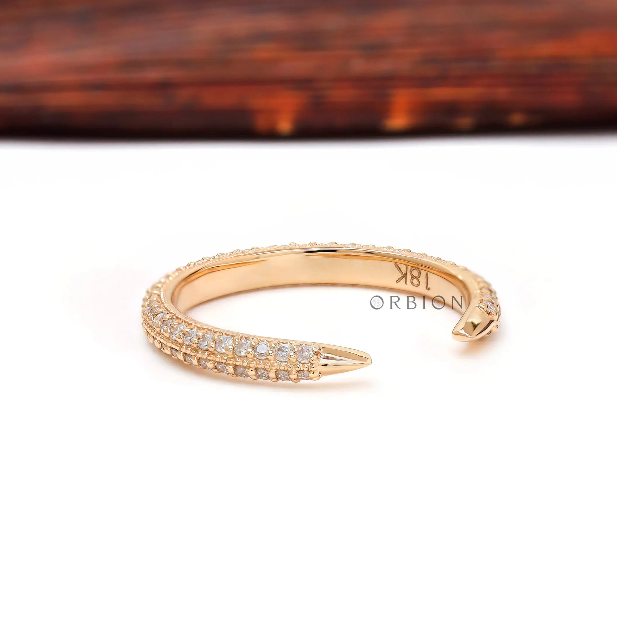 Angled view of open milgrain pave band showing pointed claw ends