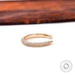 Side profile of slim open pave diamond band highlighting milgrain edges