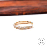 Side profile of slim open pave diamond band highlighting milgrain edges