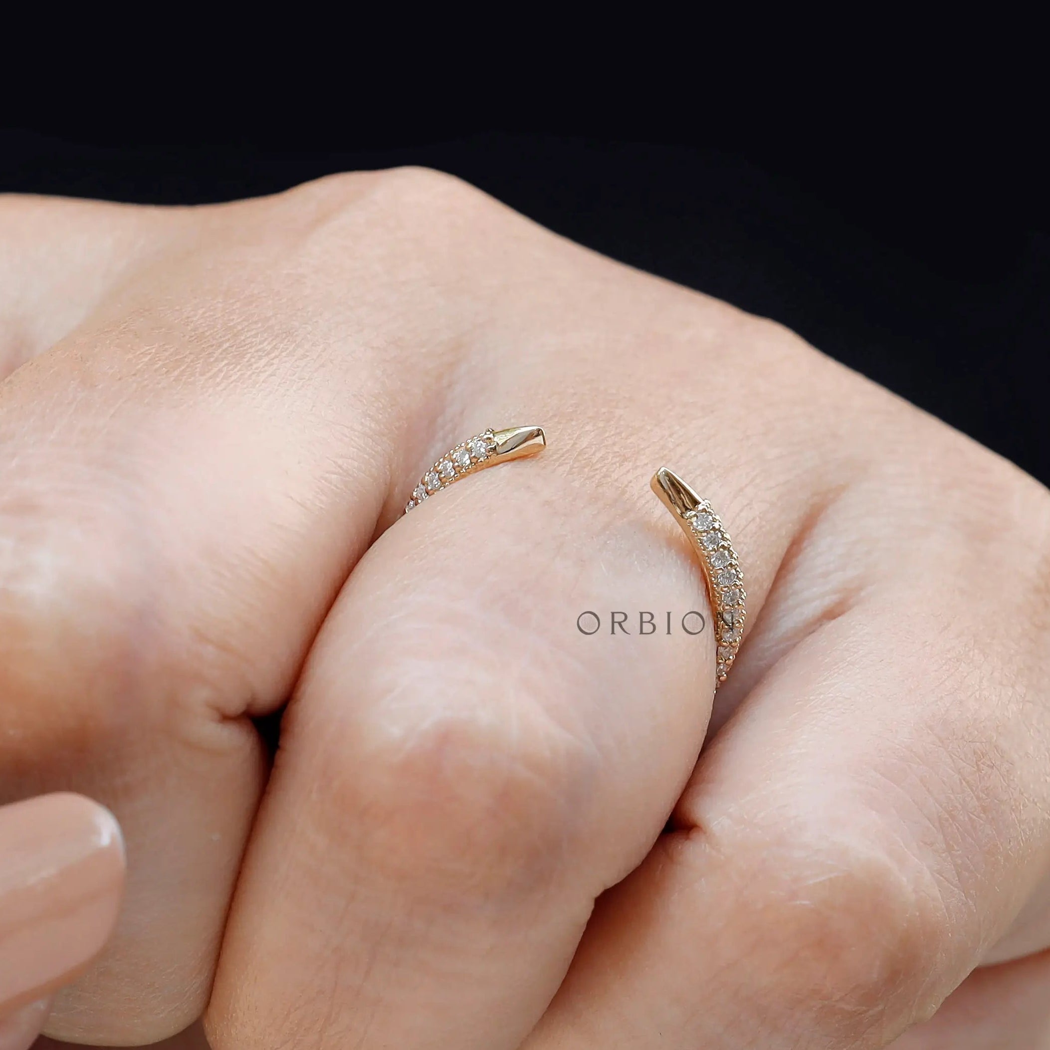 Minimal open pave spacer ring worn on finger close-up